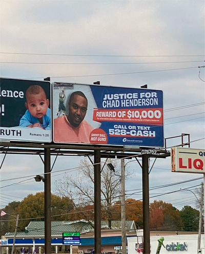 A giant billboard with the words "Justice for Chad Henderson" and 'Reward of $10,000" and "call or text 528-cash"